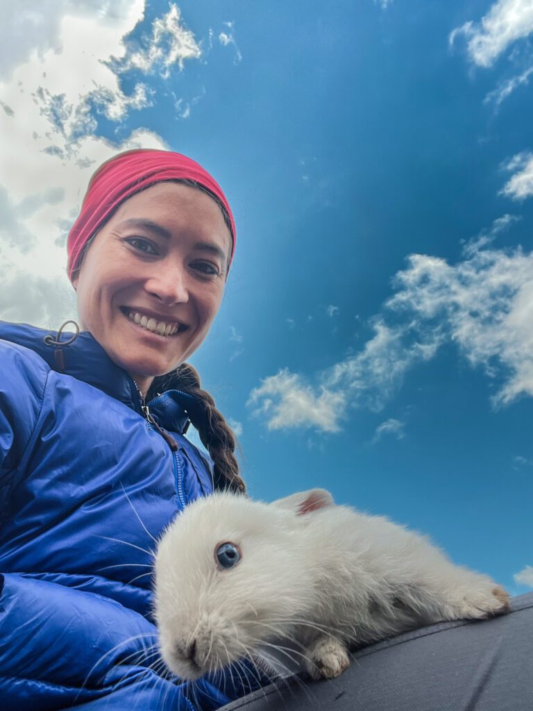 a hiker with a bunny on her lap