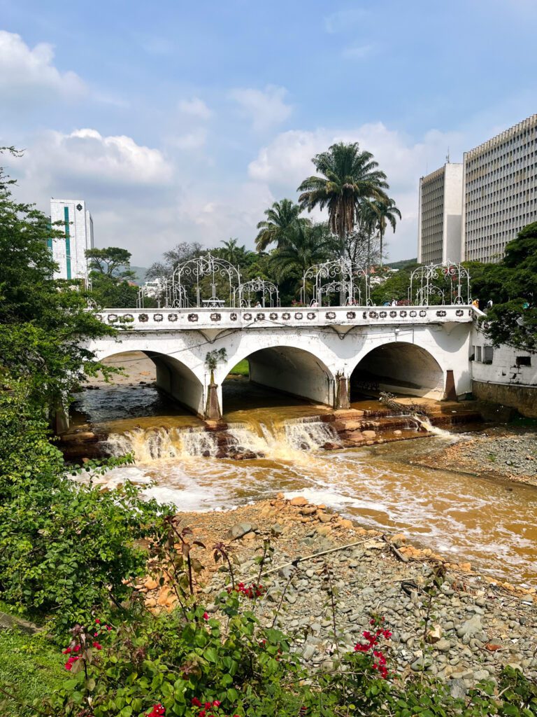 a river and bridge in the city center of cali, colombia