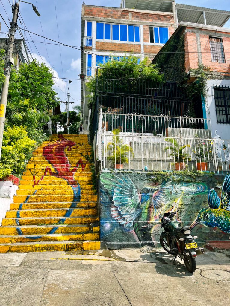 a colorful painted staircase and mural