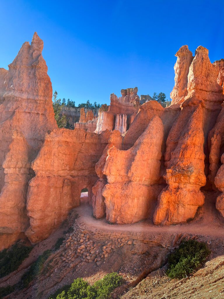 a tunnel carved into a rock formation on a bryce canyon hike