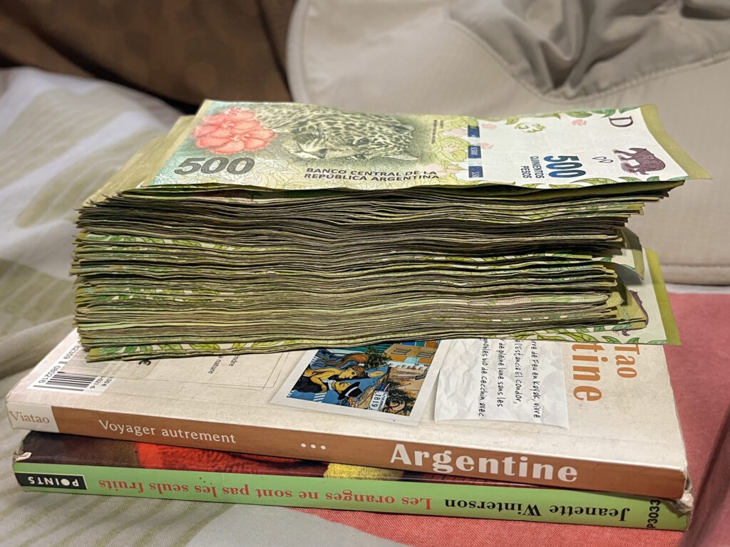 a large stack of Argentine pesos.