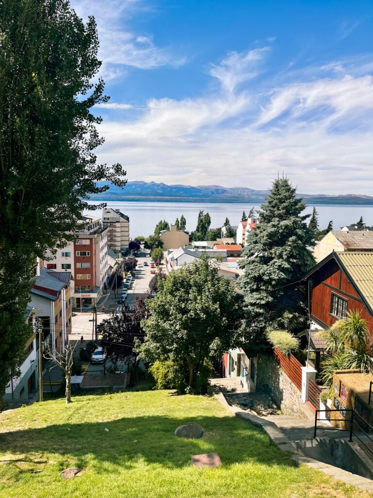 a town on a hill overlooks a lake.