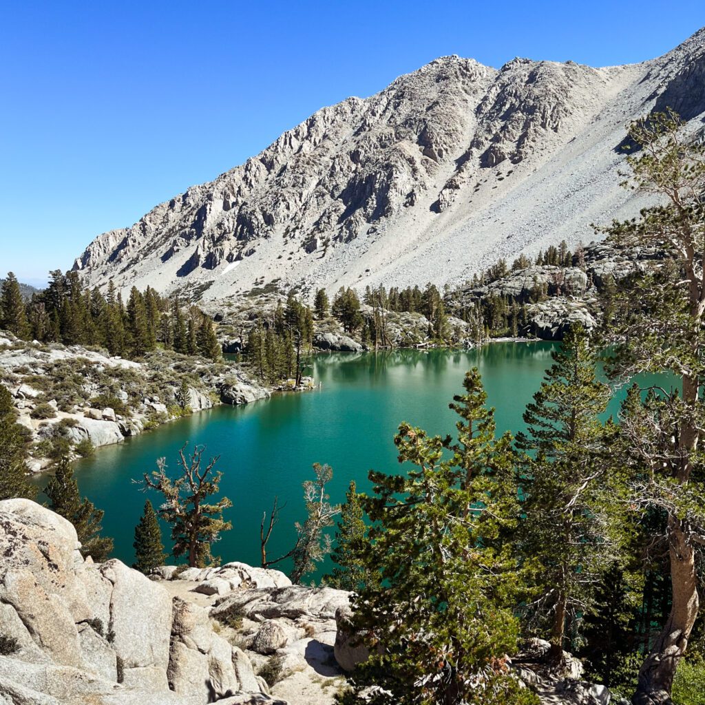 first lake, a turquoise green alpine lake on the big pine lakes trail in california's eastern sierra mountains