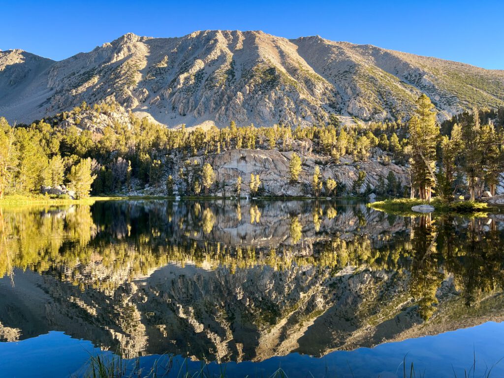 Perfect reflection of mountains in an alpine lake on the Big Pine Lakes trail.