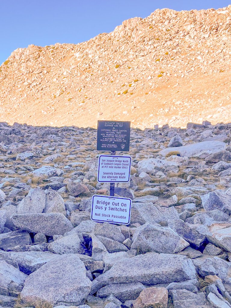 A sign at the top of the rocky mountain pass at bishop pass