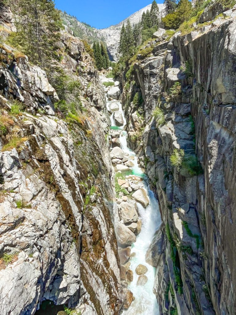 an aerial view of a rushing alpine river in a canyon along the high sierra trail