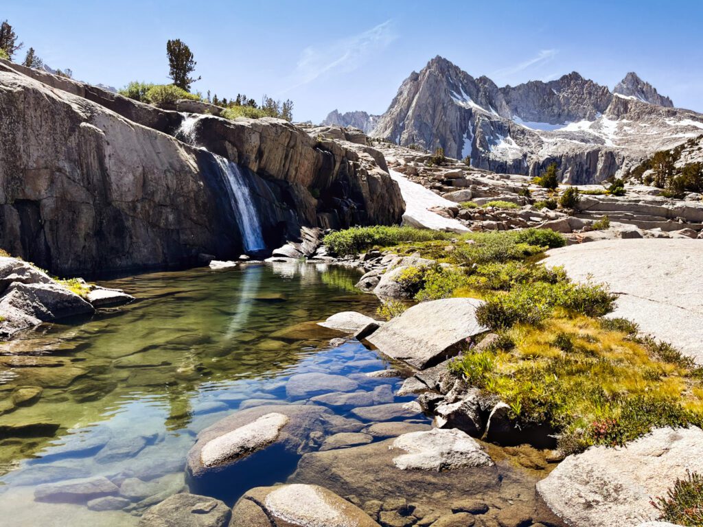 a crescent-shaped waterfall visited on a backpacking trip.