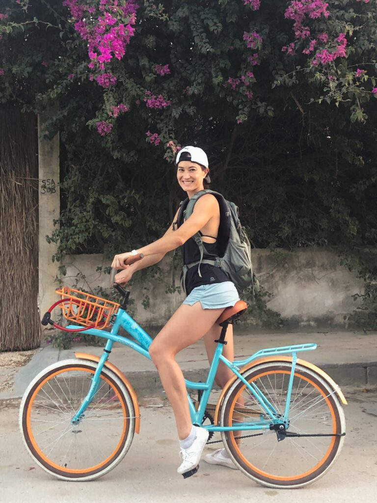 a woman rides a bicycle to save money for travel