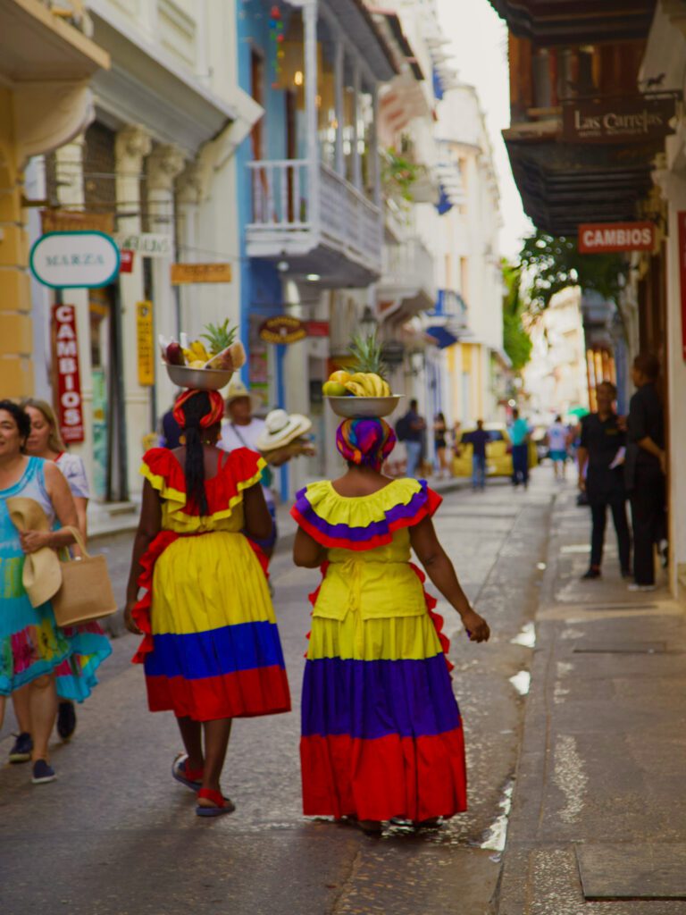 palenqueras, women dressed in colorful clothing and selling fruit in cartagena, colombia