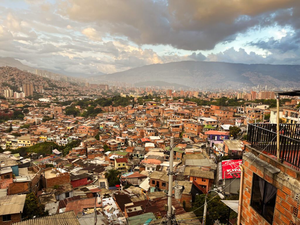 a view overlooking the dense hilltop neighborhood of comuna 13 in medellin, colombia