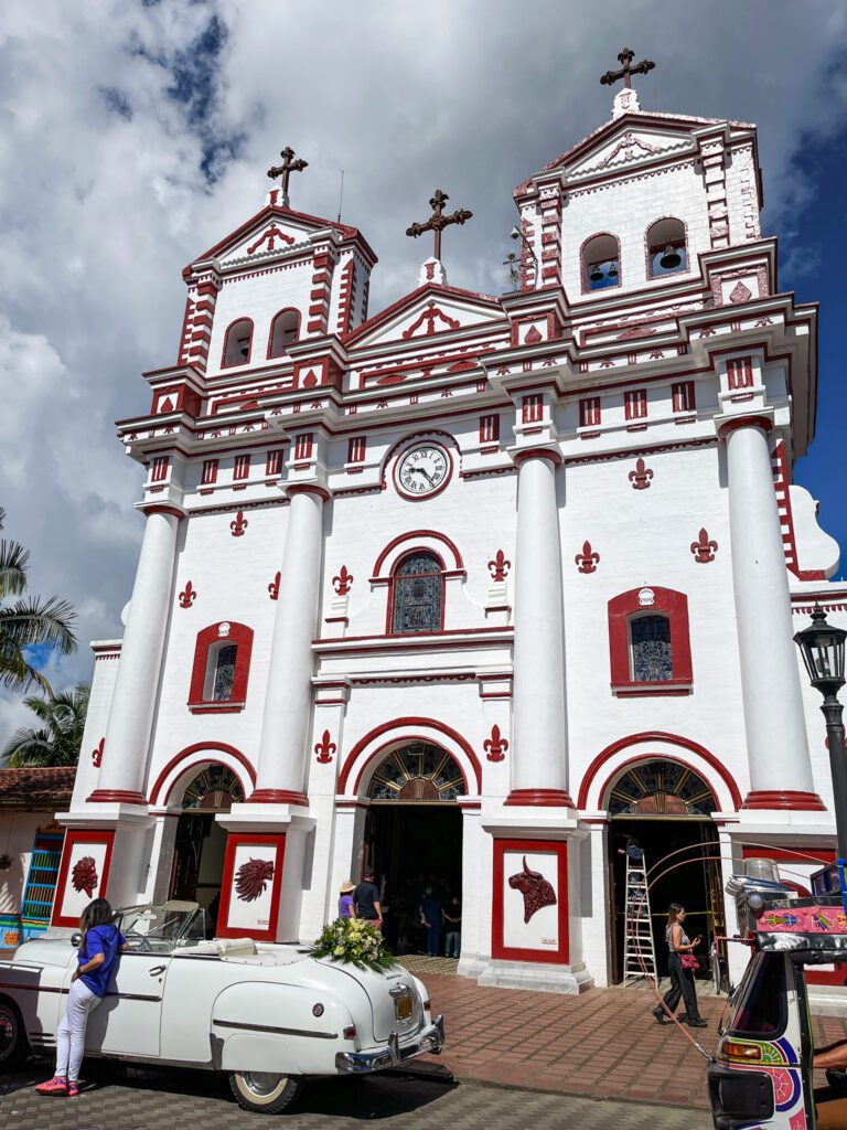 a white and red colonial style church in colombia