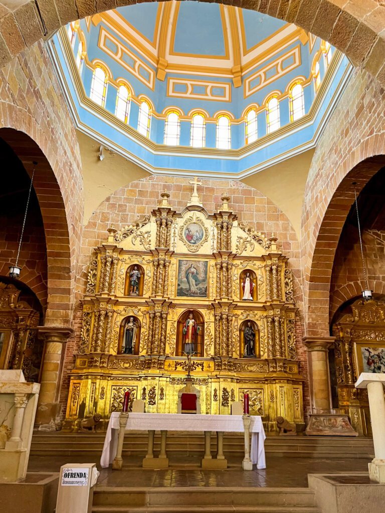 the interior of a colonial cathedral in san gil, colombia