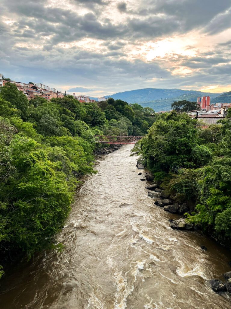 a river running through a mountainous town in colombia